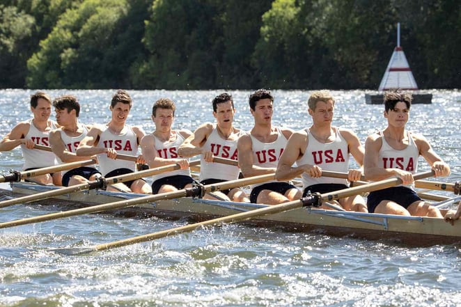 Olympic crew team rowing together in a boat